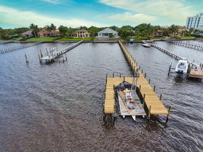 Aerial view of residential waterfront docks with one dock under marine construction