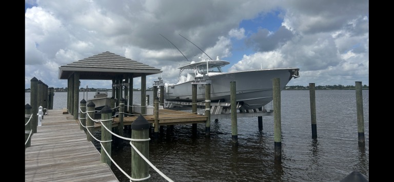 Various types of boat lifts at a marina in Port St. Lucie