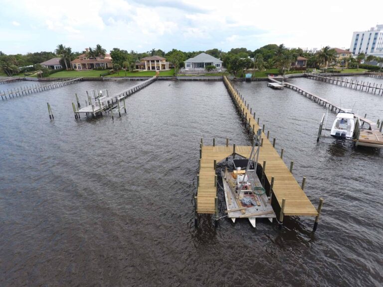 Aerial view of residential waterfront docks with one dock under marine construction